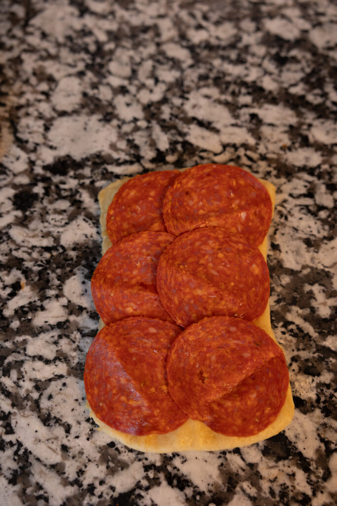 pepperoni on a piece of dough