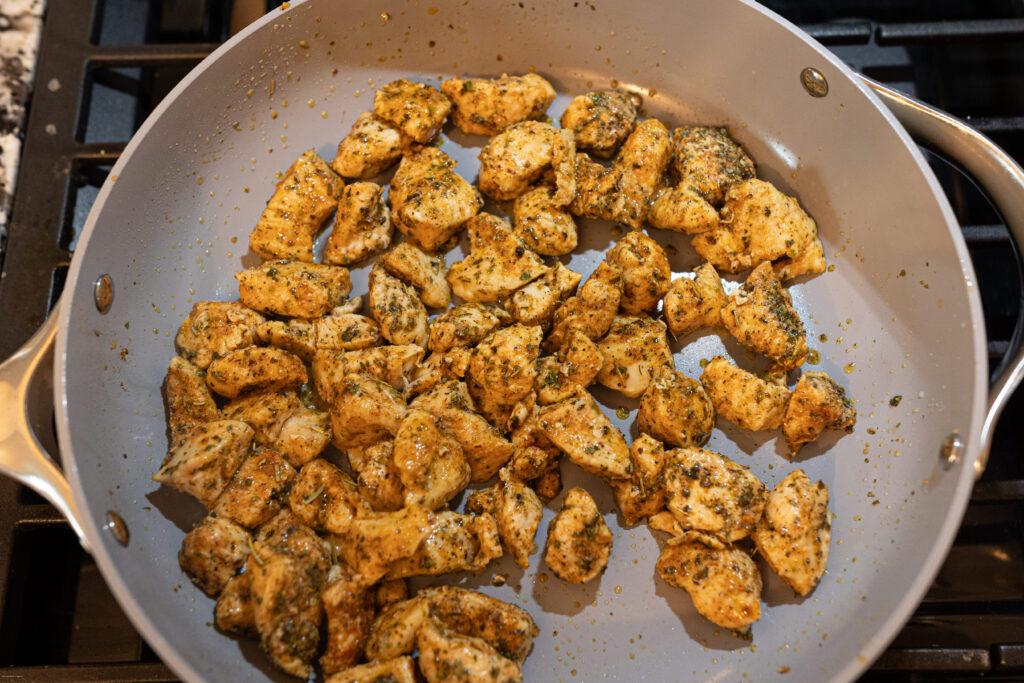 Diced chicken cooking in a pan 