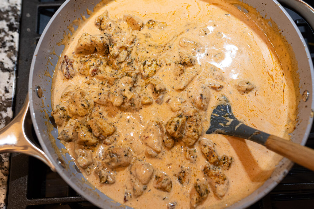 A cream sauce with chicken in it